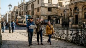 Tourists exploring Oxford landmark buildings street view