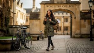 Oxford student walking beside college quad