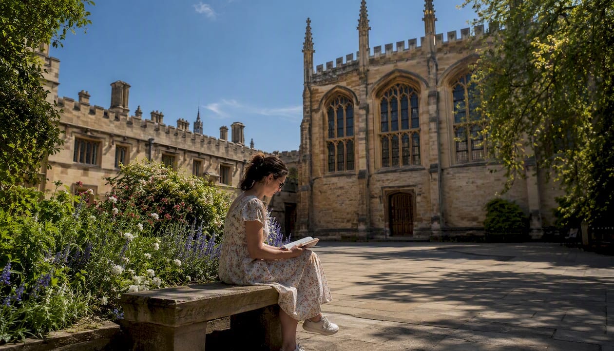 Visitor reading guidebook at Bodleian Library exterior